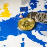 Monedas físicas con logos de criptomonedas arriba de un mapa europeo.